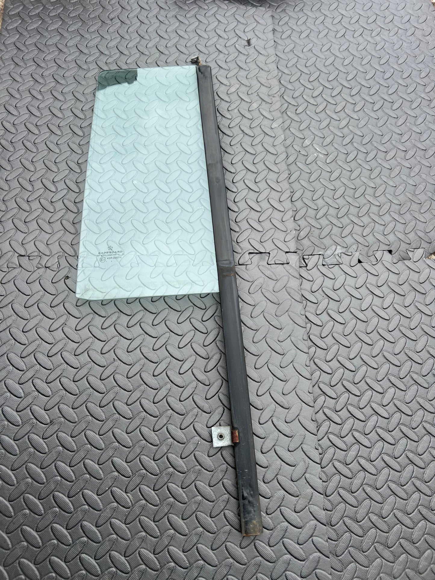 Drivers side rear fixed door glass